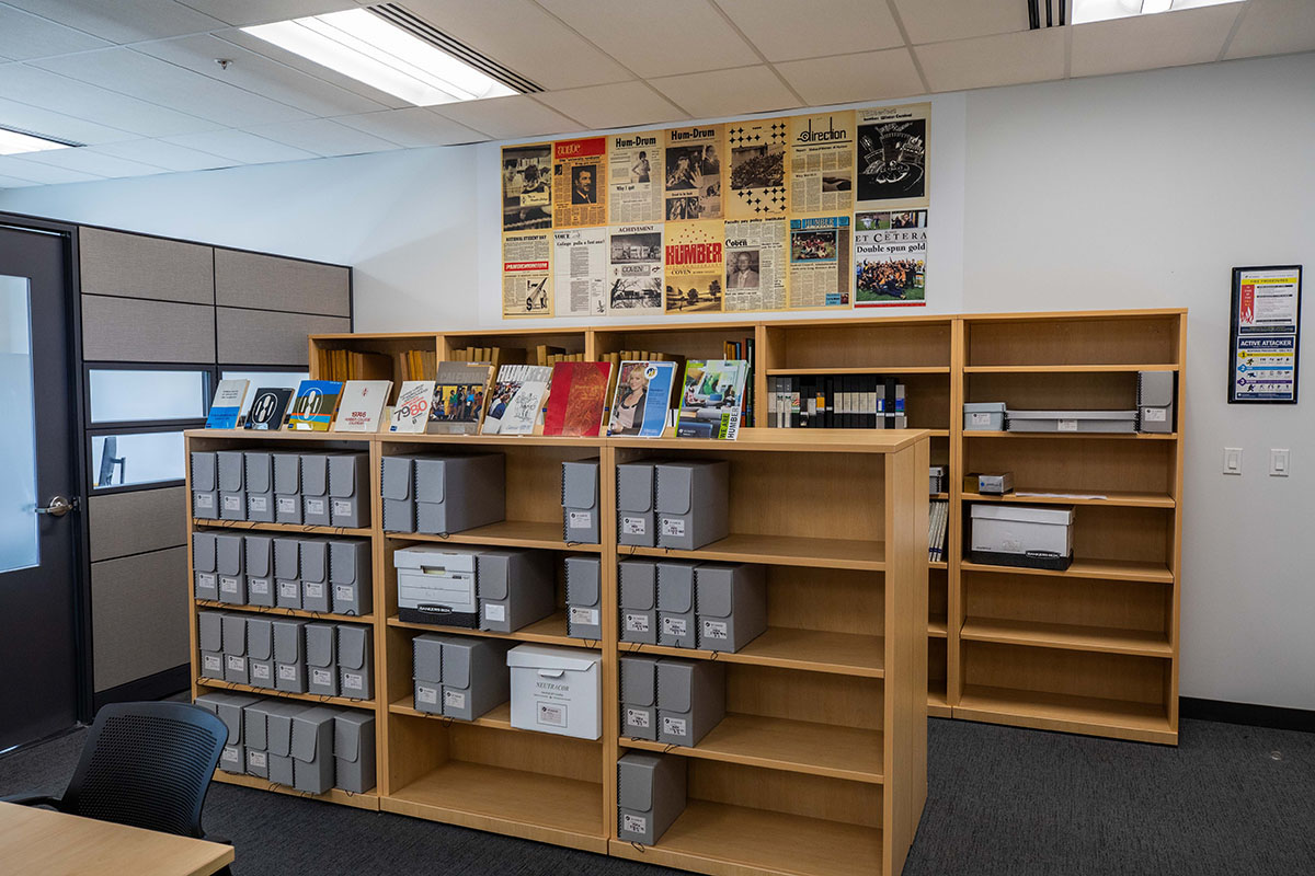 Bookcase with grey archival boxes in the Humber College Archives room