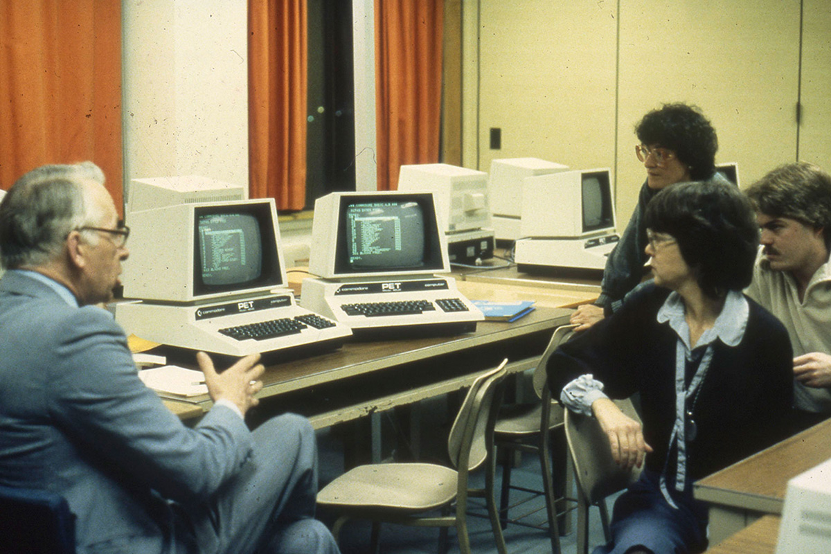 Faculty member with students in a computer lab